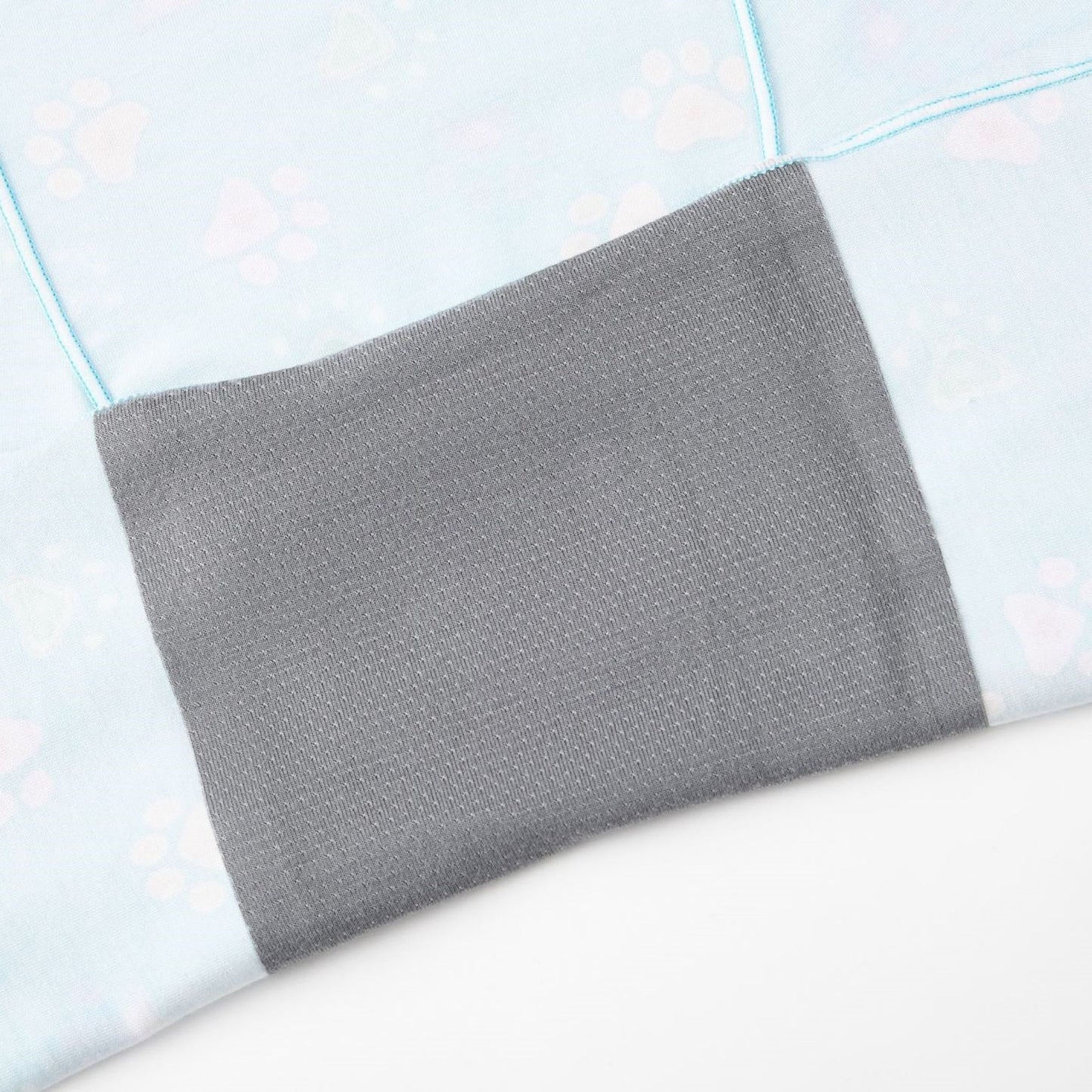 Close-up of Puresnug Pawfect, a soft, light blue fabric with pastel paw prints, featuring an attached gray gusset