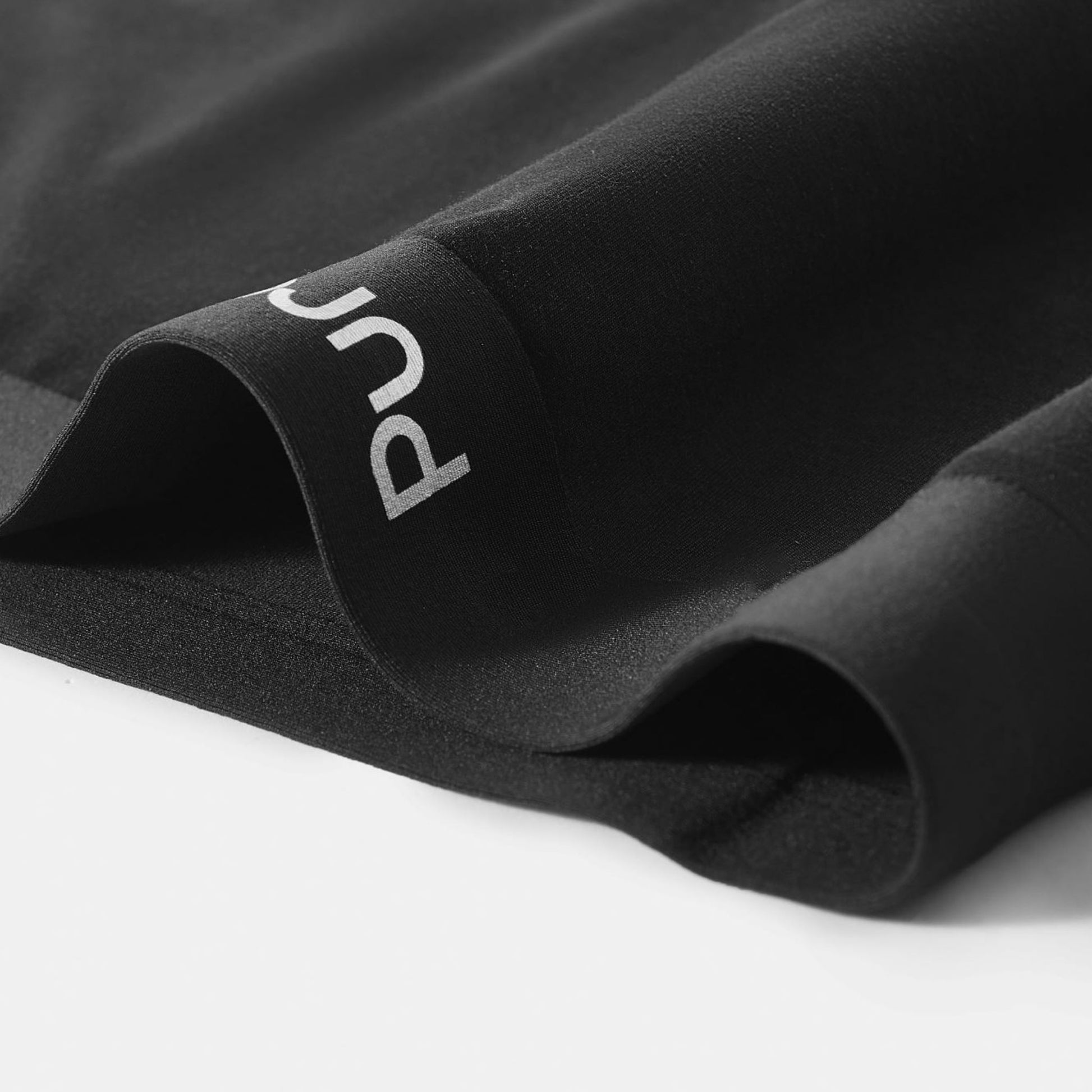 Black fabric with a brand logo on a white background