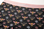 Black underwear with whimsical bee and snowflake patterns, featuring a soft pink waistband with "PureSnug" text.
