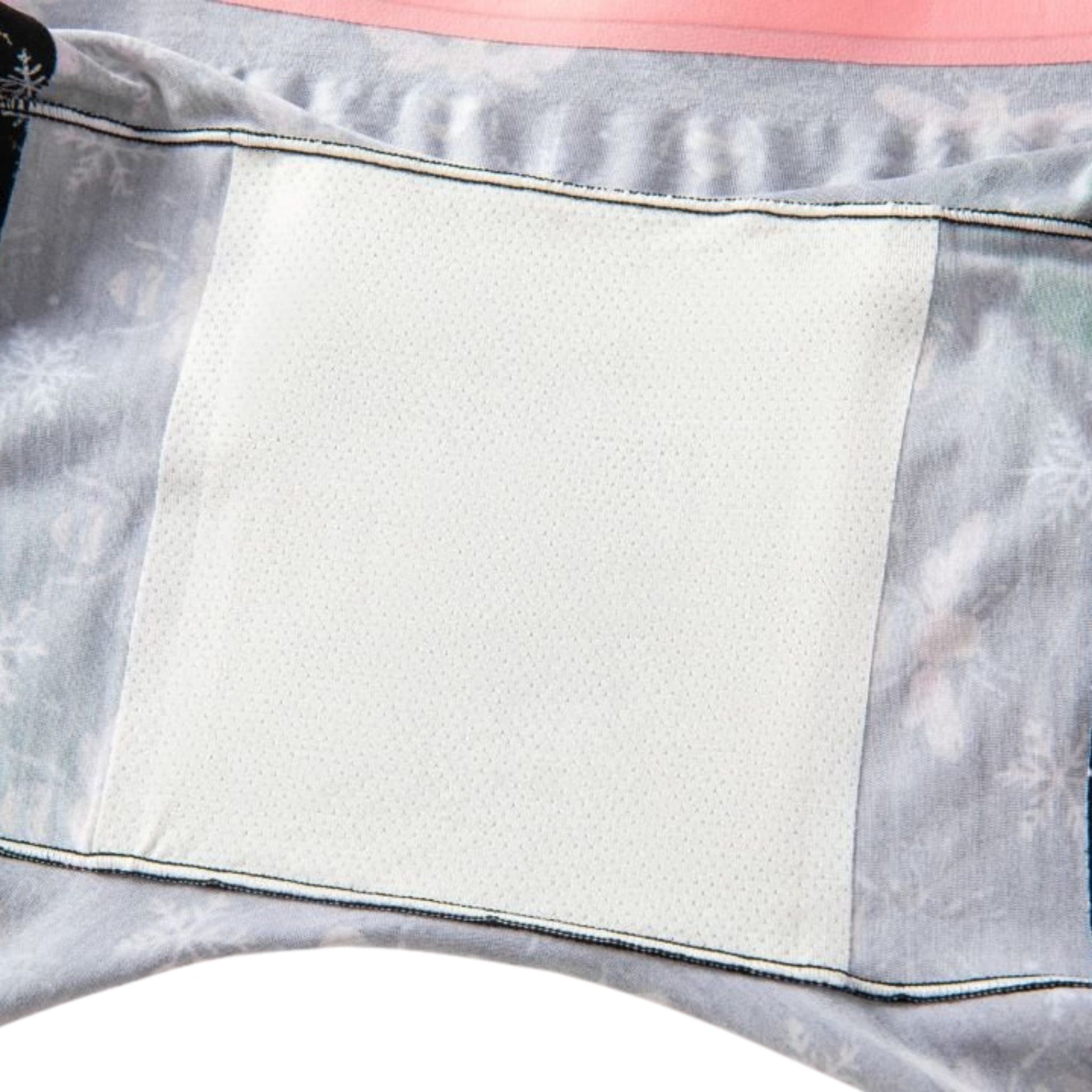 Close-up of a gray and pink fabric with a white attached gusset