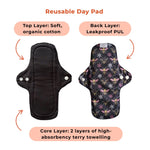 Two reusable day pads shown side by side. The left pad features a soft, organic cotton top layer, while the right pad displays a colorfully patterned, leakproof PUL back layer with bees and flowers.