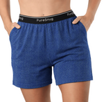 A close-up of a person wearing denim colour lounge shorts with a black elastic waistband printed with the brand name 'PureSnug' in white. The model's hands are in the pockets, and the background is white.