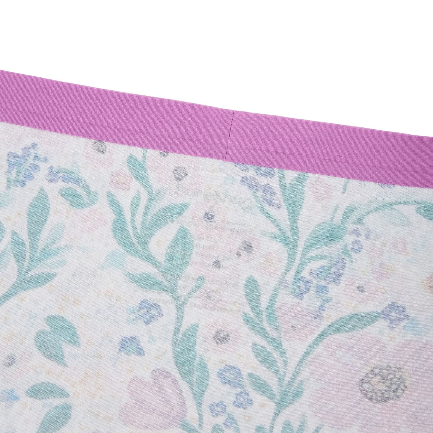 Close-up of the interior waistband of PureSnug underwear, featuring a purple elastic band and printed care label on
