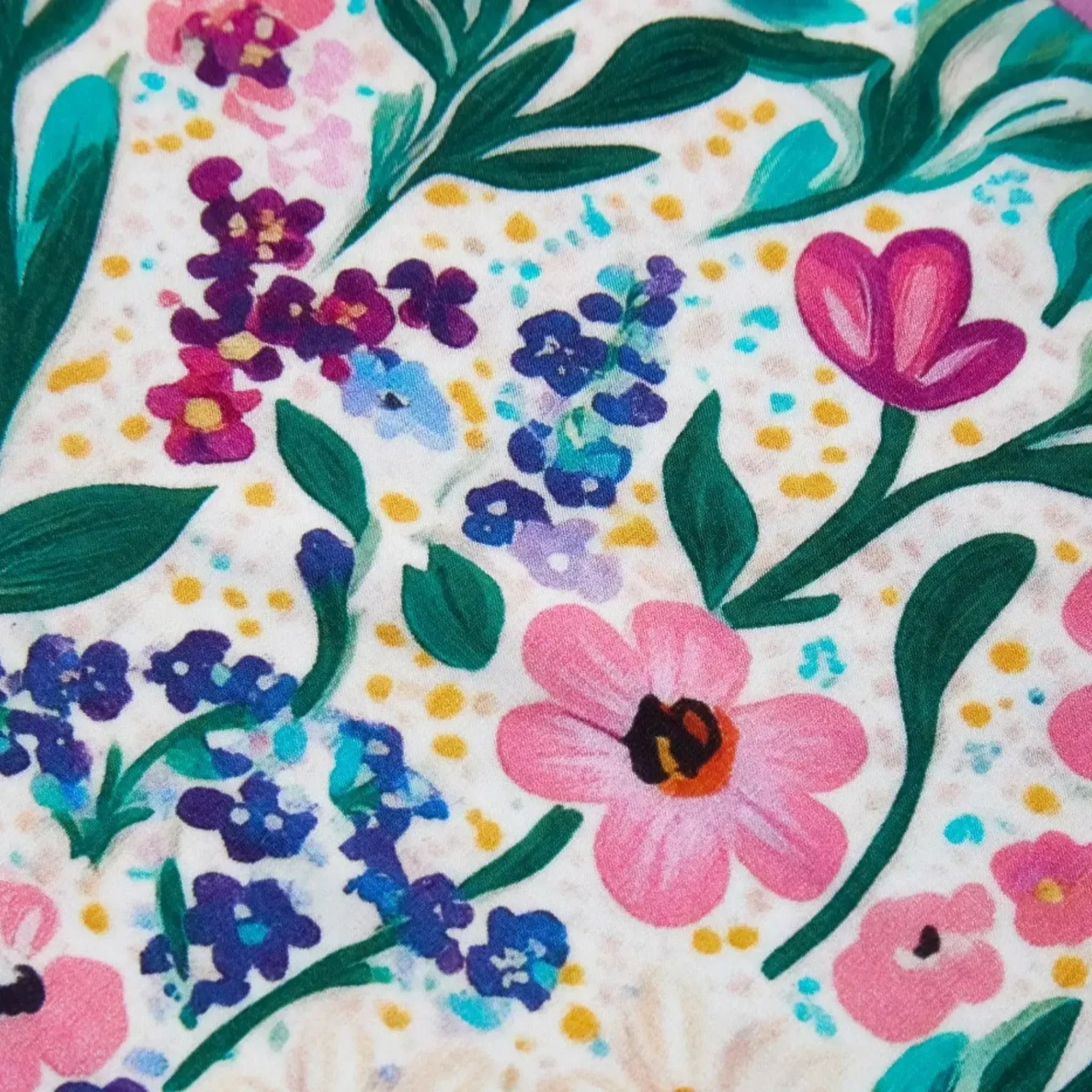 Colorful floral pattern of PureSnug Meadow Muse featuring various flowers in pink, purple, and blue hues with green leaves