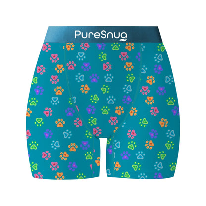 Bright blue fabric with colorful paw print patterns in yellow, pink, green, and blue, and the brand name "PureSnug"