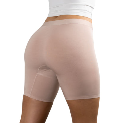 Back view of person wearing seamless Blush Beige nude-colored PureSnug women boxer shorts with white top