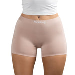 Model wearing PureSnug boyshorts in Blush Beige, focused on shorts and torso area.
