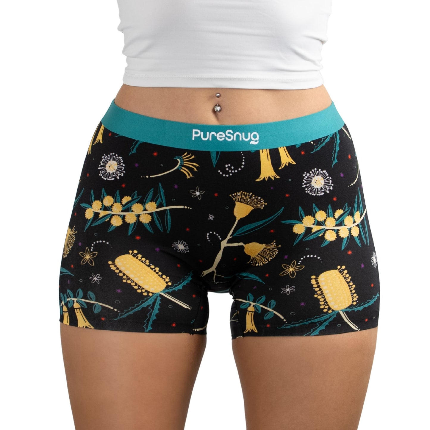 Model wearing PureSnug Golden Snug floral-print boyshort underwear with teal logo waistband, labeled as new arrival.