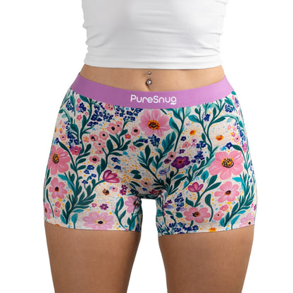 Person wearing Meadow Muse floral print PureSnug boyleg boyshort underwear with white crop top