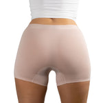Back view of woman wearing PureSnug's Blush Beige boyshorts made from smooth, stretchy fabric