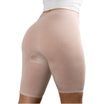 A woman wearing PureSnug high-waisted, nude-colored, seamless shaping shorts, with a white top.