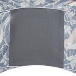 Gray gusset square on a floral patterned fabric background
