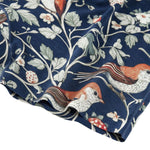 Fabric with bird and floral pattern on a blue background